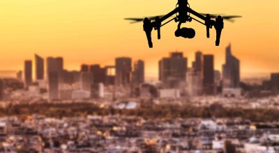 Drone silhouette flying above Paris city panorama